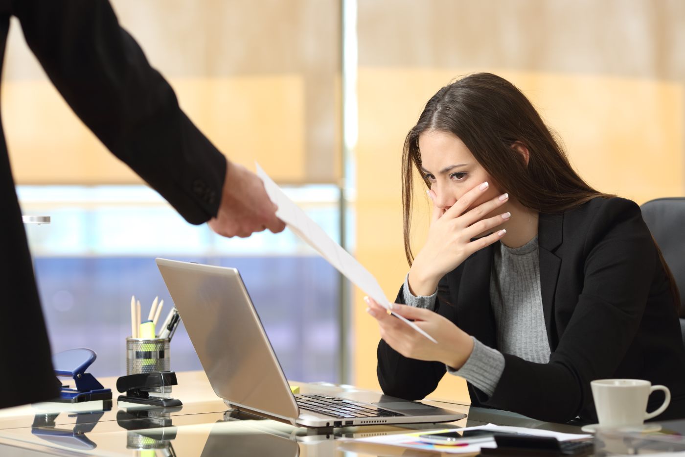 Man handing over termination letter to women
