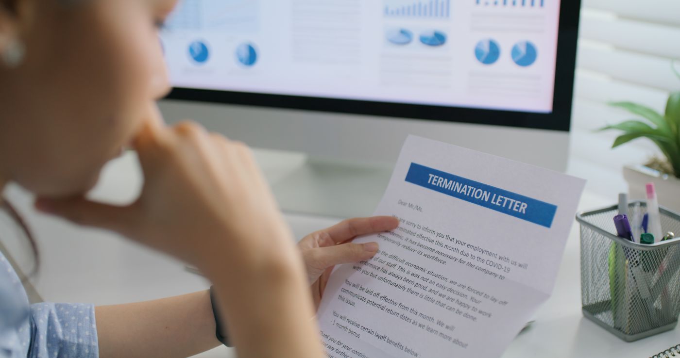 Women reading termination letter in office