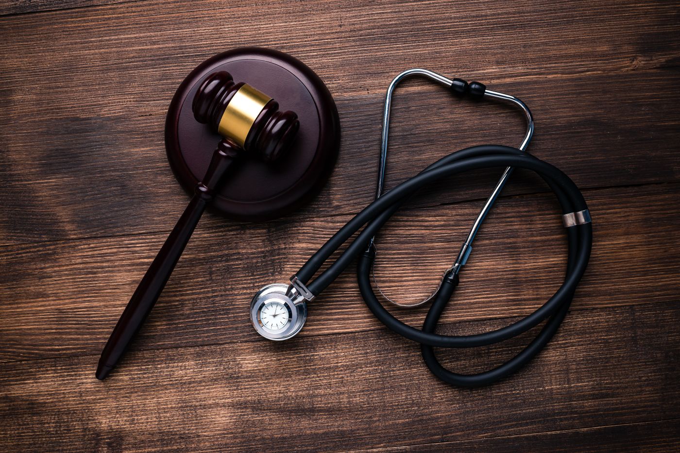 Gavel and stethoscope in table