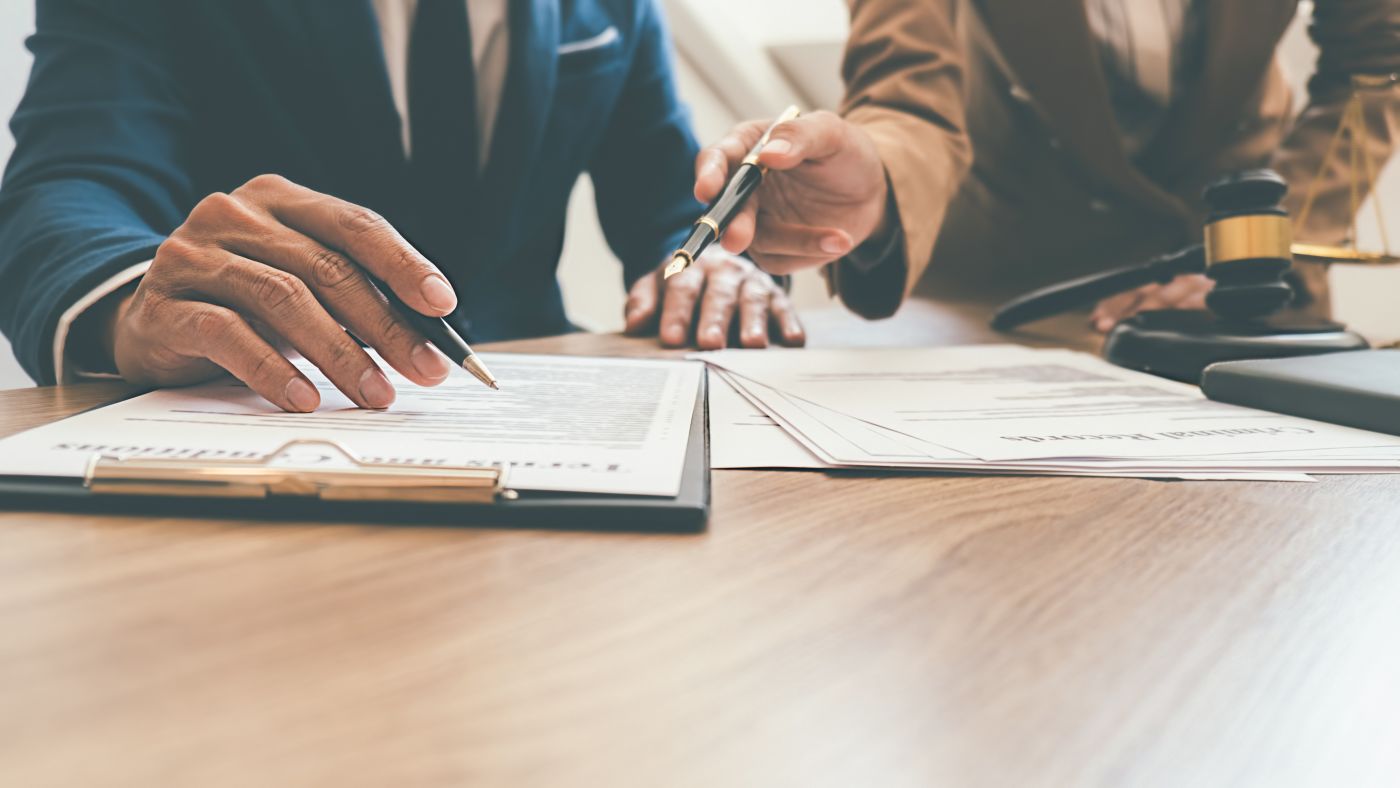 Businessmen discussing legal option with lawyer