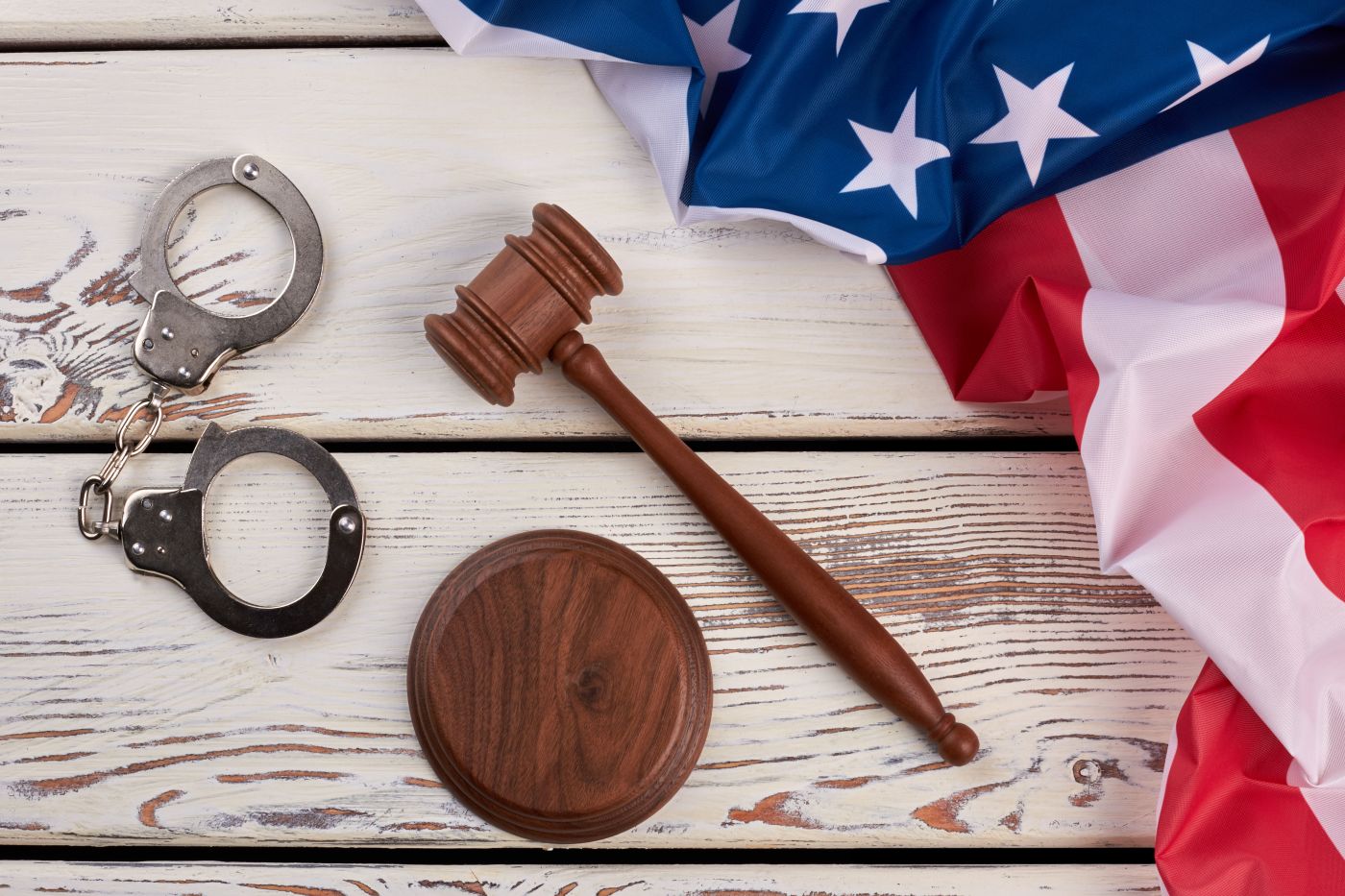 Handcuffs, wooden gavel and USA flag
