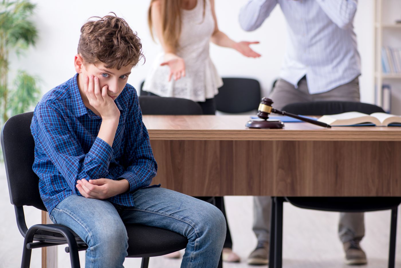 Arguing parents with frustrated child in attorney office