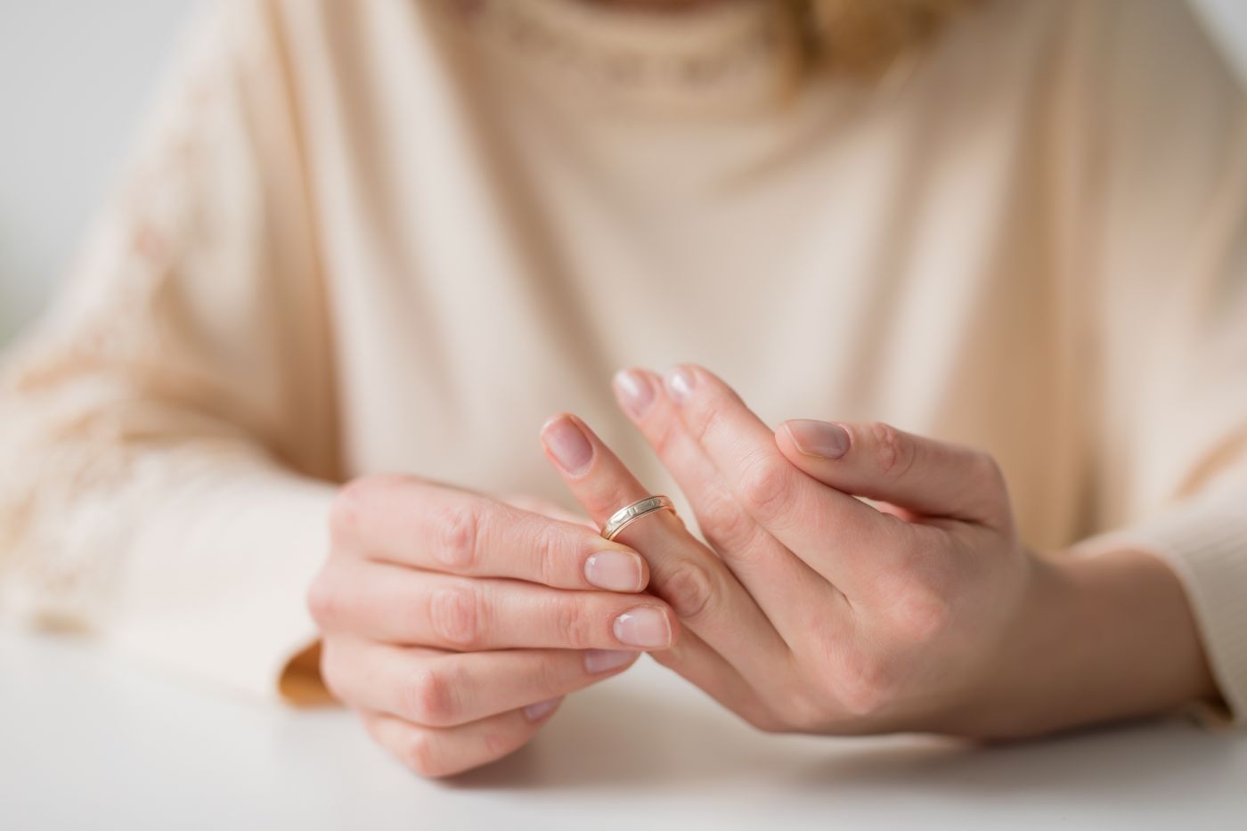 Women removing wedding ring from hand