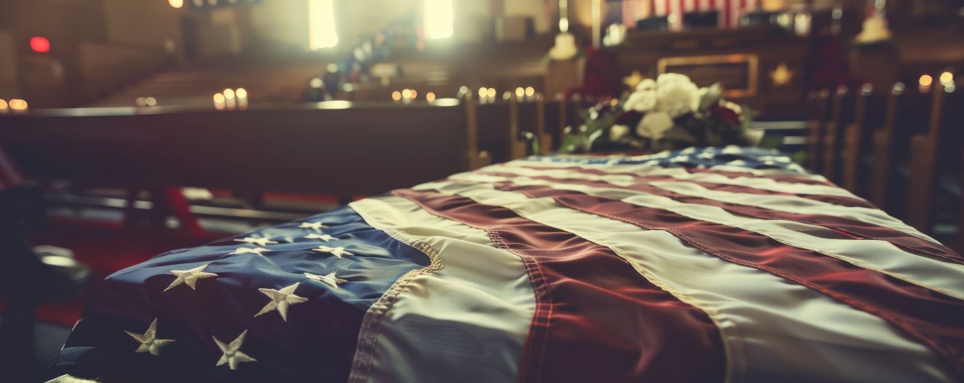 American flag draped on coffin at military funeral