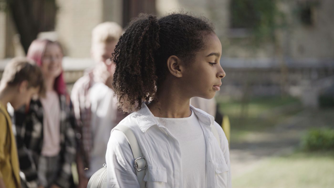 School kids bullying unhappy biracial girl