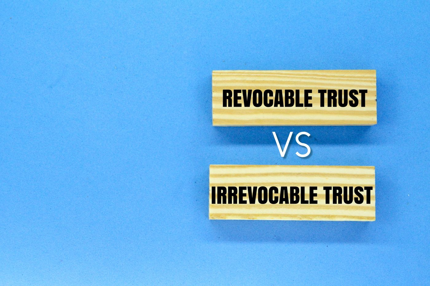 Words Irrevocable Trust vs Revocable Trust in wooden tiles