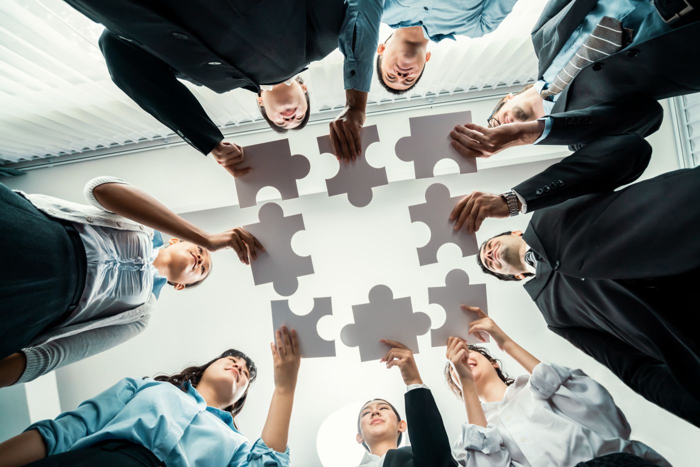 Business Partners holding puzzle pieces in hand