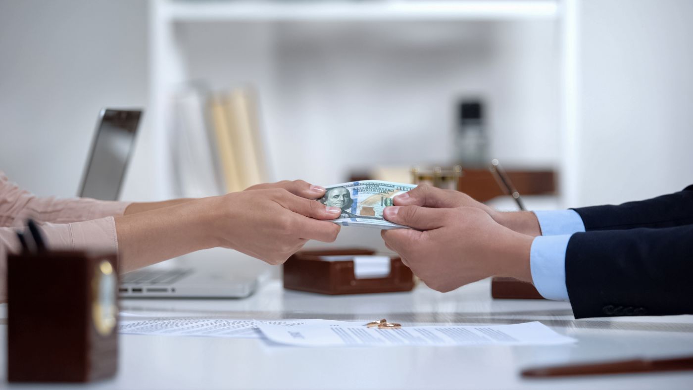 Male and Female hands pulling money