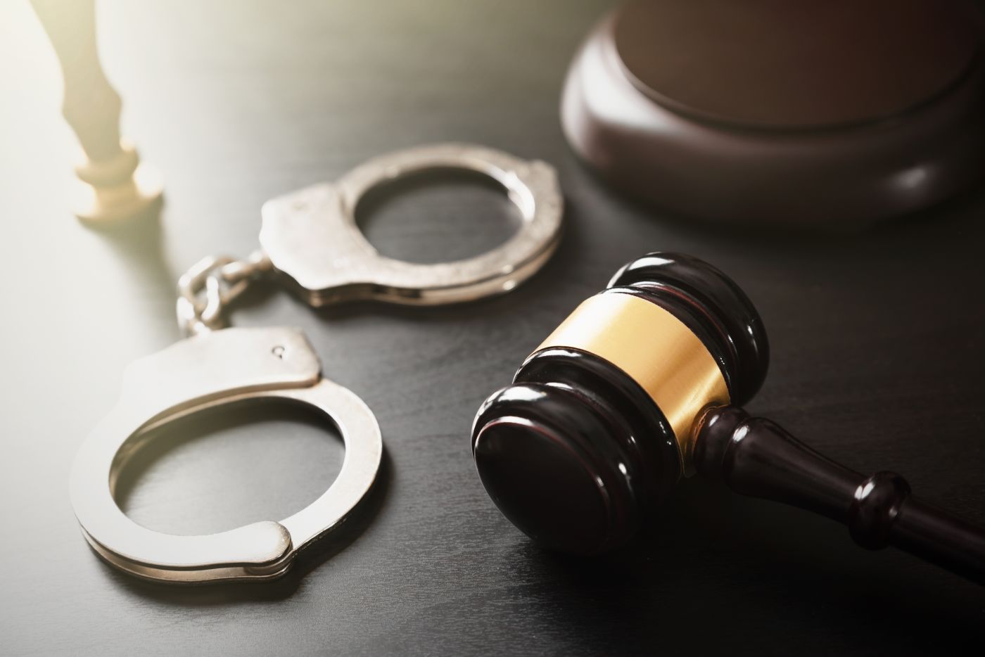 Gavel and handcuff in table