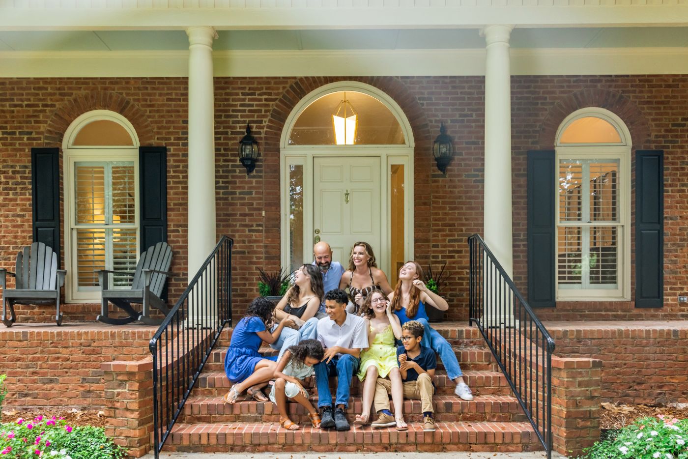 Blended Family sitting on front steps of house