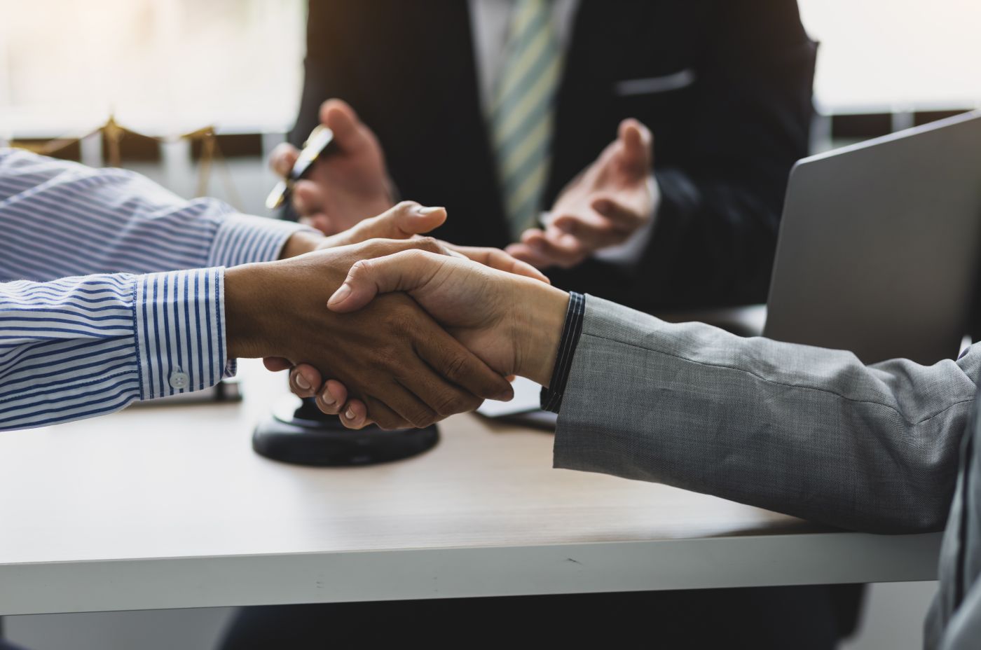 Two parties shaking hand after successful mediation