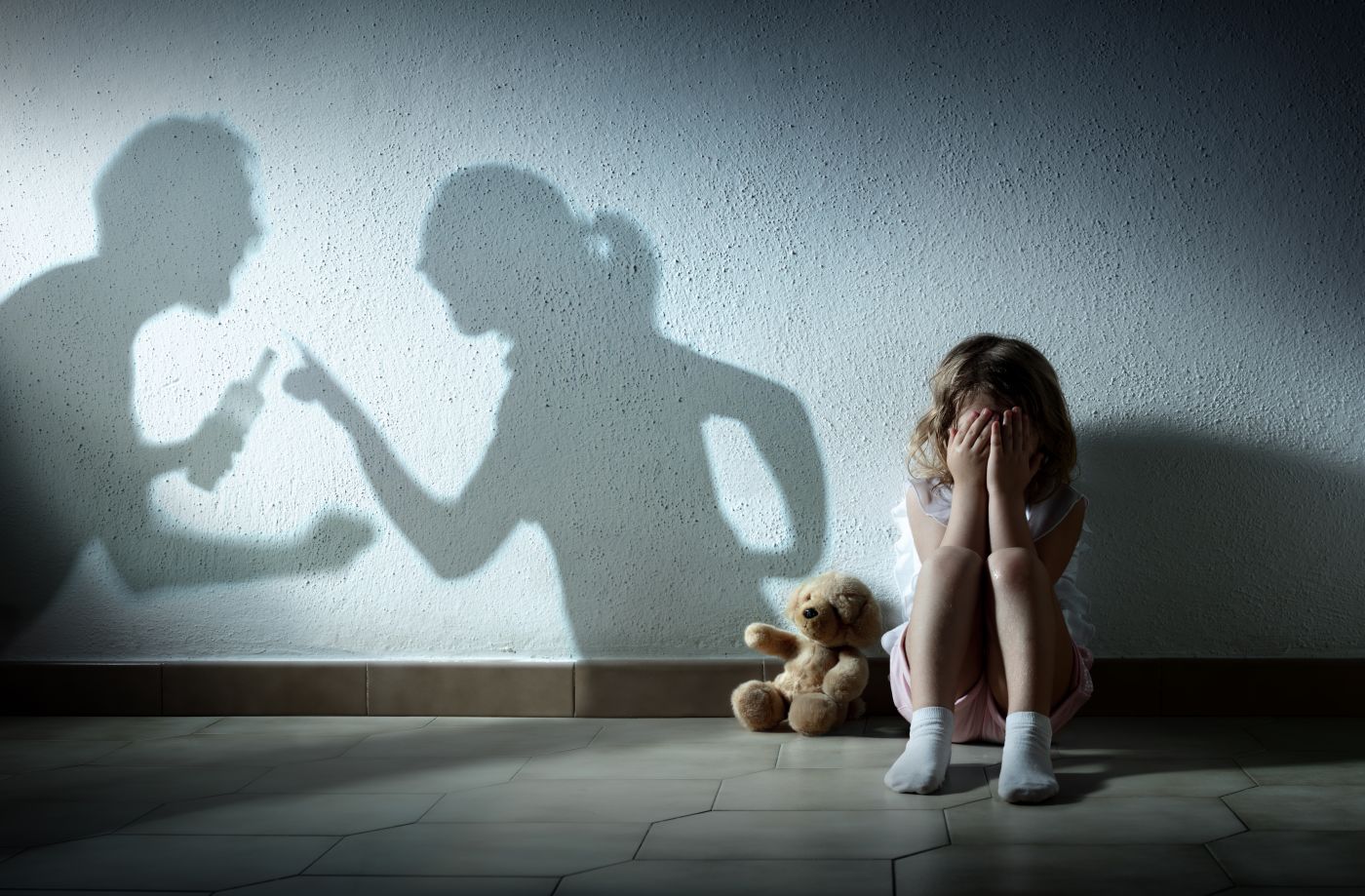 Little Girl Crying With Shadow Of Parents Arguing