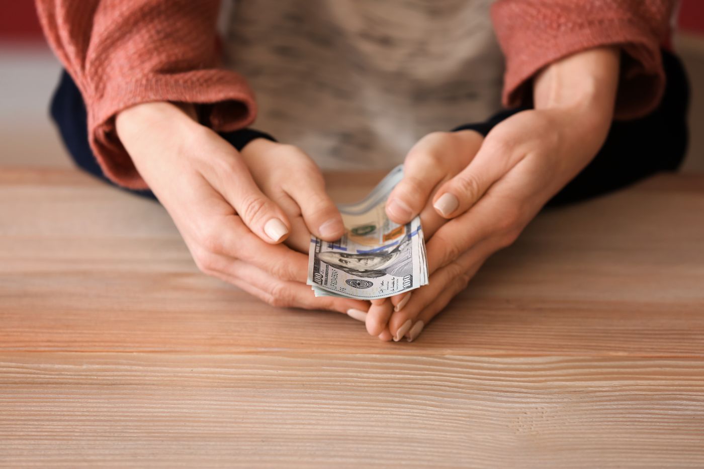 Mother and child holding dollar bills in hand