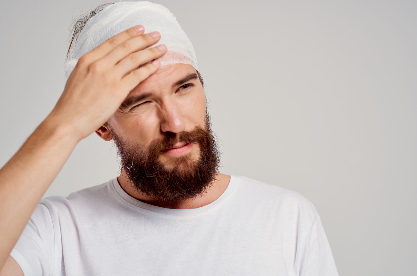 Man with bandaged head feeling pain