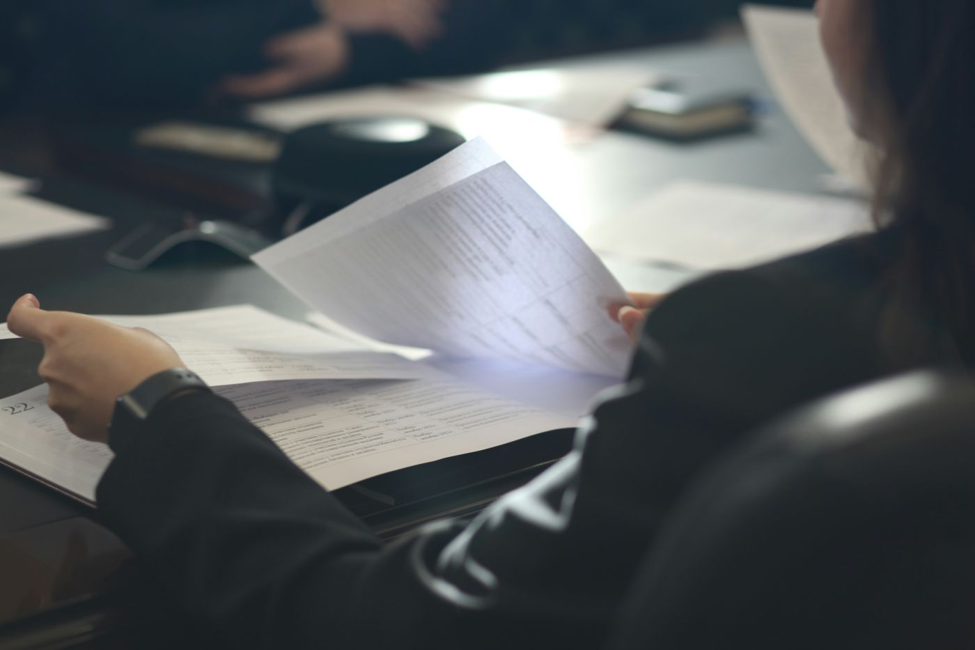Woman attorney reviewing detailed injury and medical documentation at her desk
