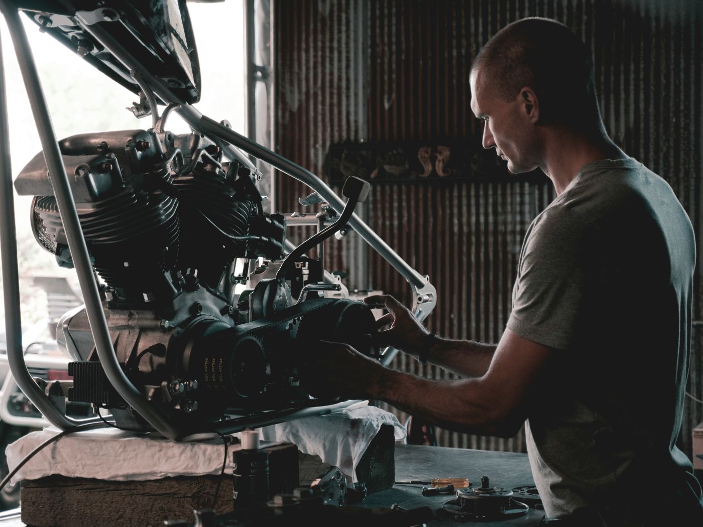 Male mechanic working on a car engine
