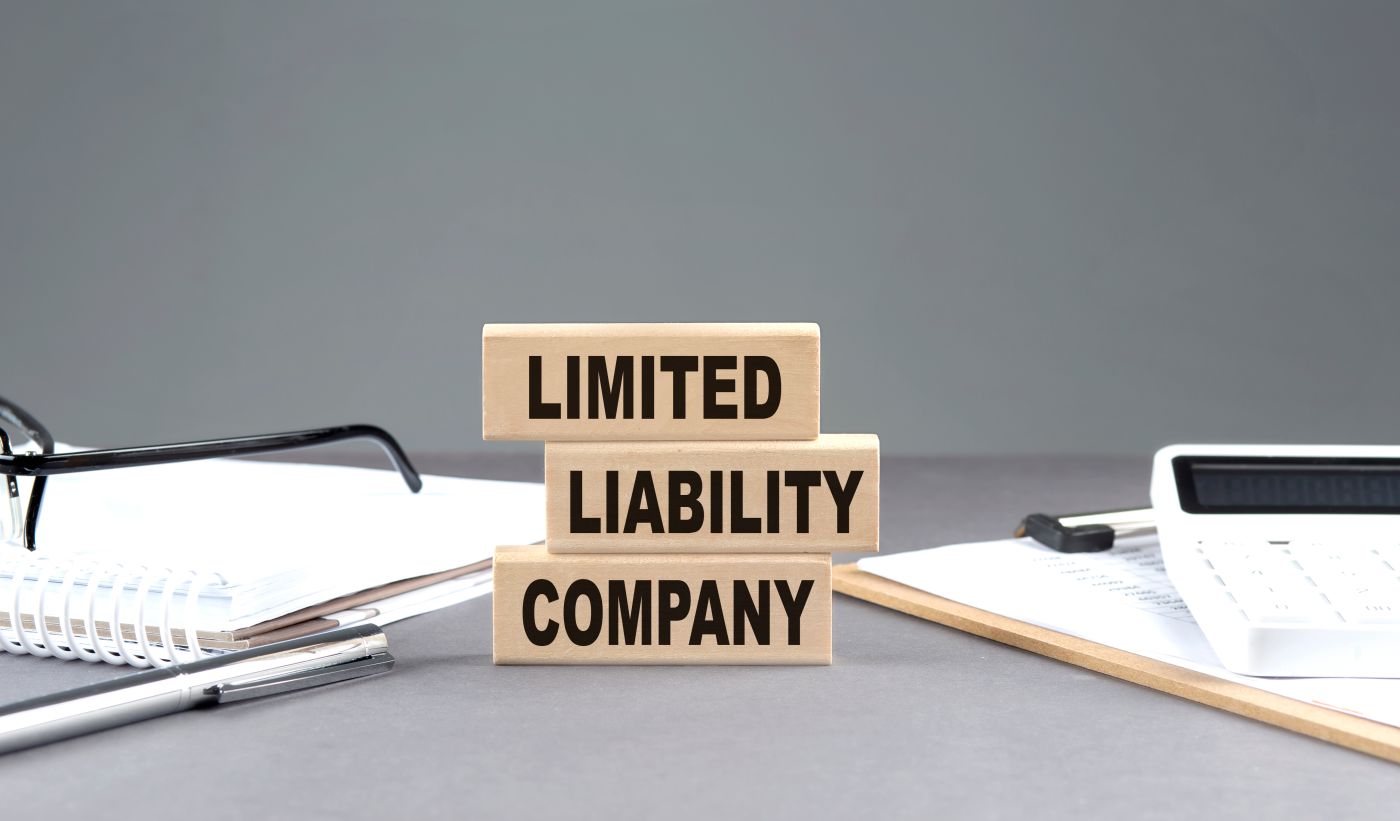 LLC Limited Liability Company text on wooden block