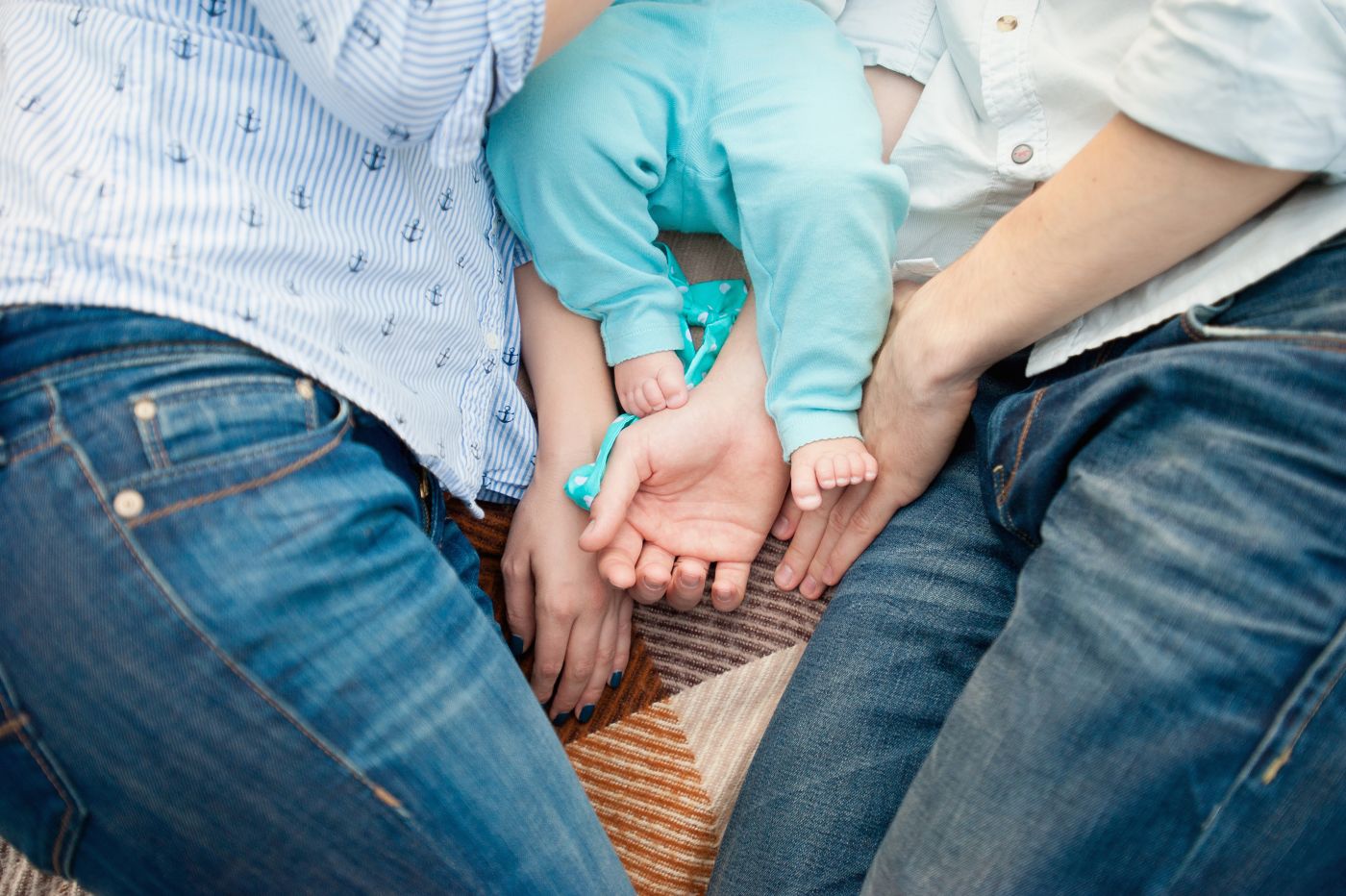 Baby feet on father and mother hands