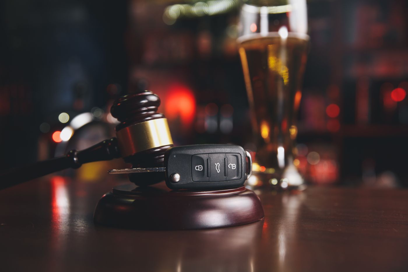 Glass of Alcohol, Car keys and gavel in table