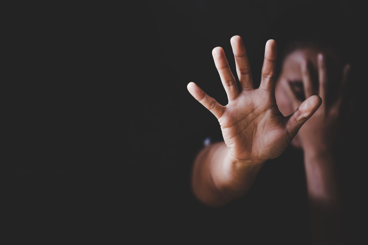 Women showing hands as an indication to stop domestic violence