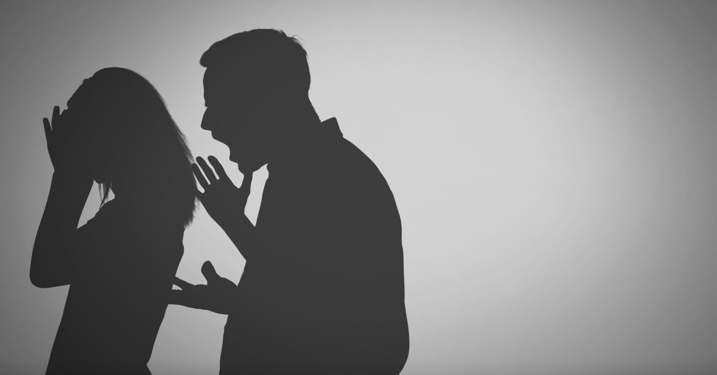 Silhouette of man shouting at women