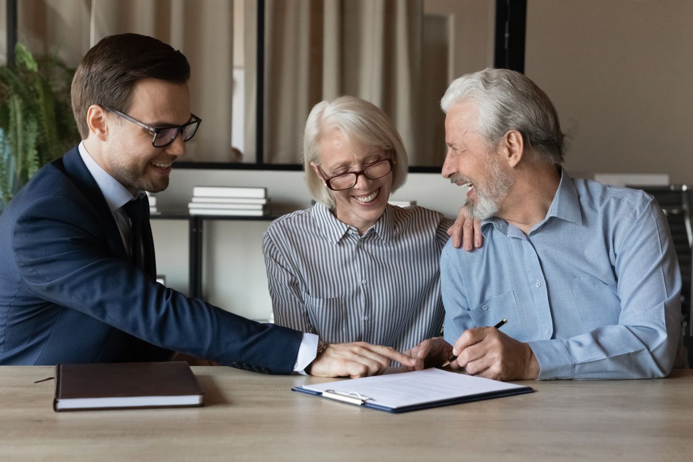 Happy couples signing estate planning document