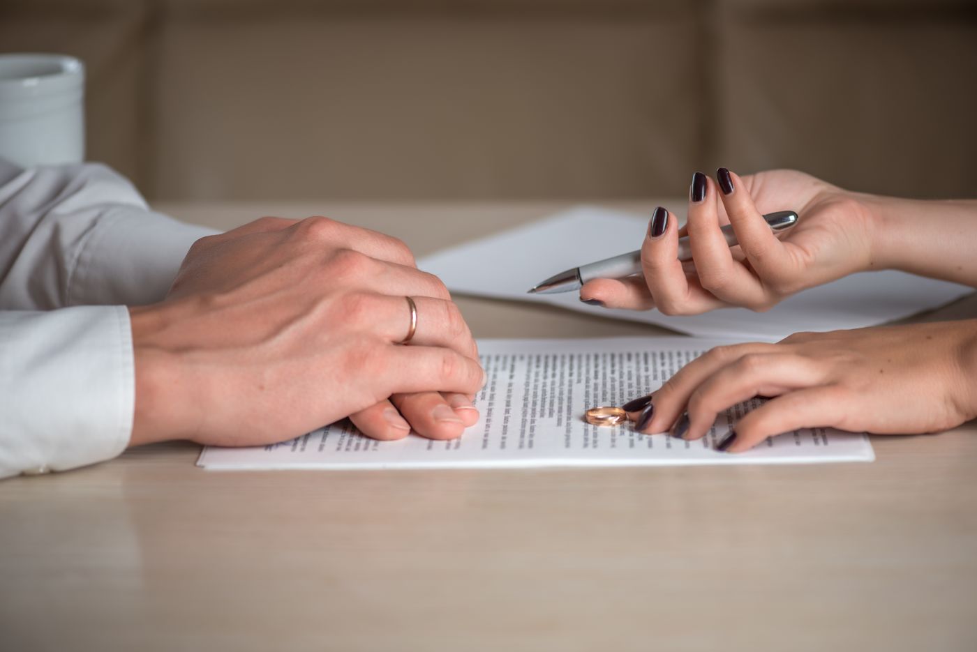 Women gives divorce document and pen to husband