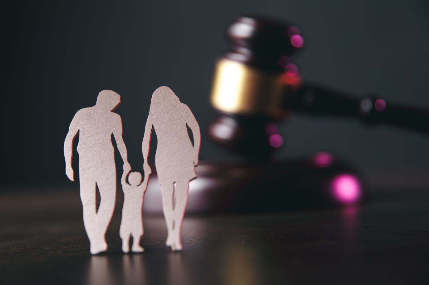 Family figure and gavel on table