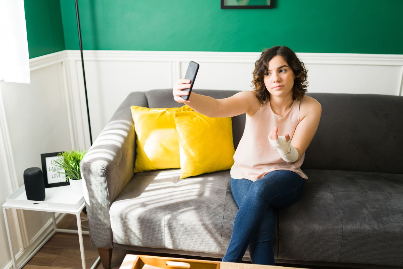 Women with injured hand clicking photo