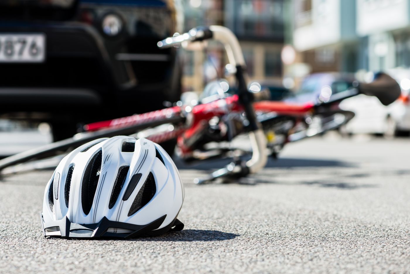 Bicycle and helmet on road after crash