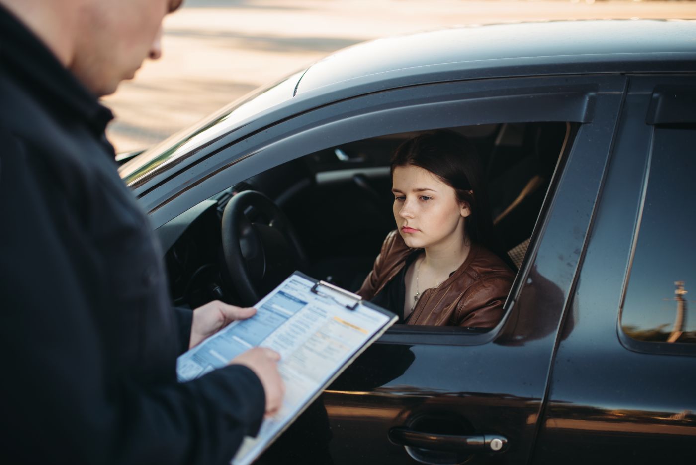 Female driver getting booked for traffic violation