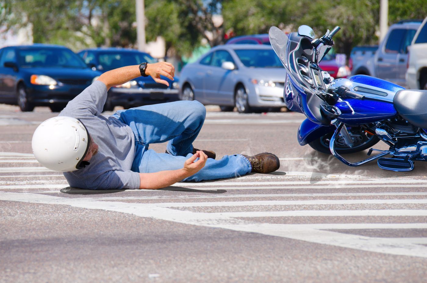 Rider and Motorcycle on road after accident