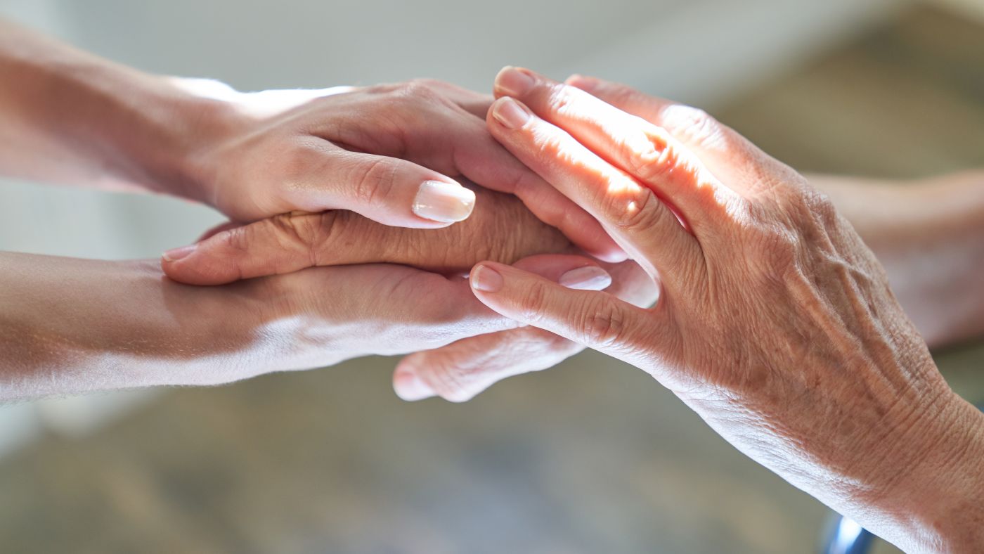 Young hands holding old person hand, Guardianship concept