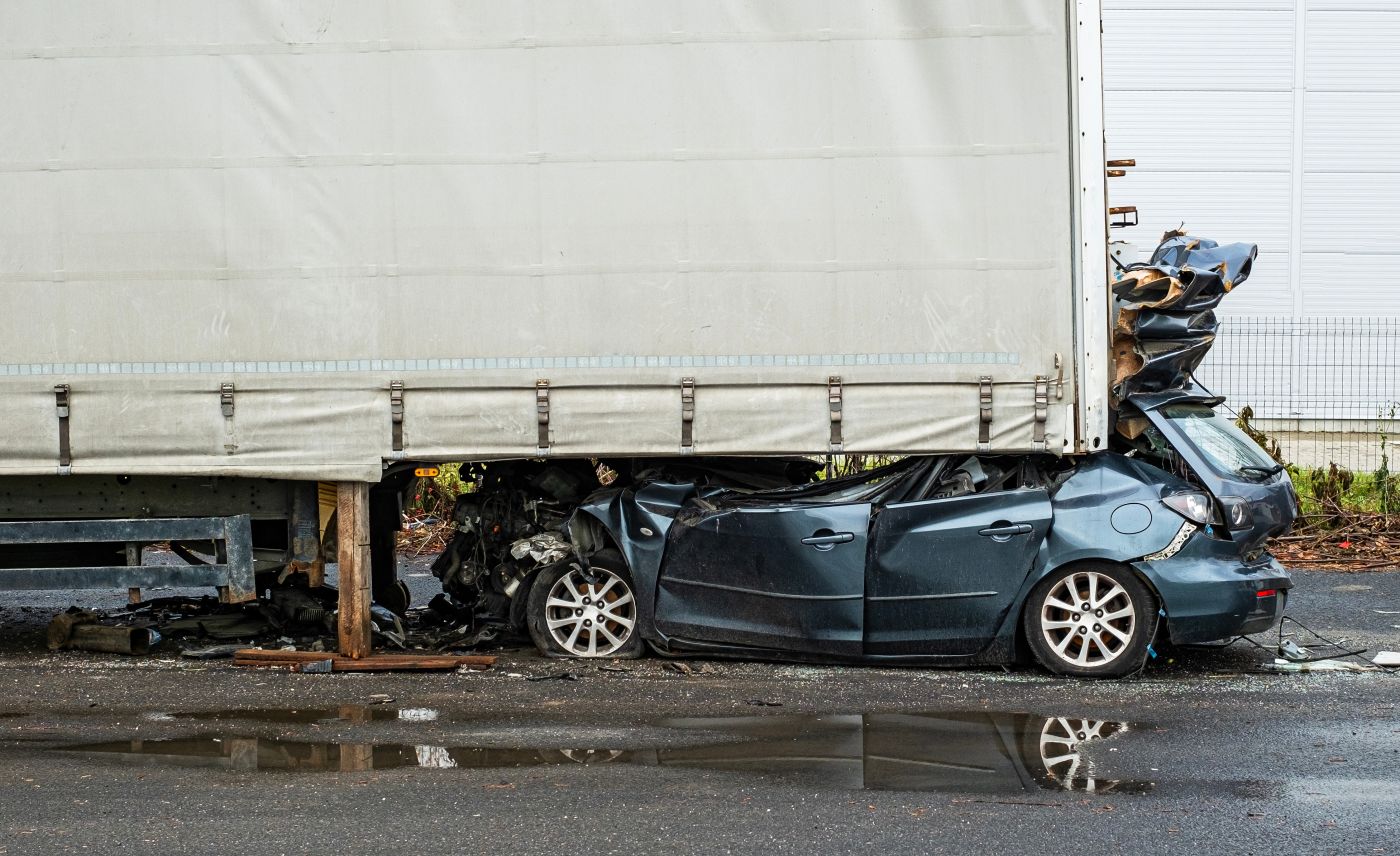 Car smashing into rear of a truck