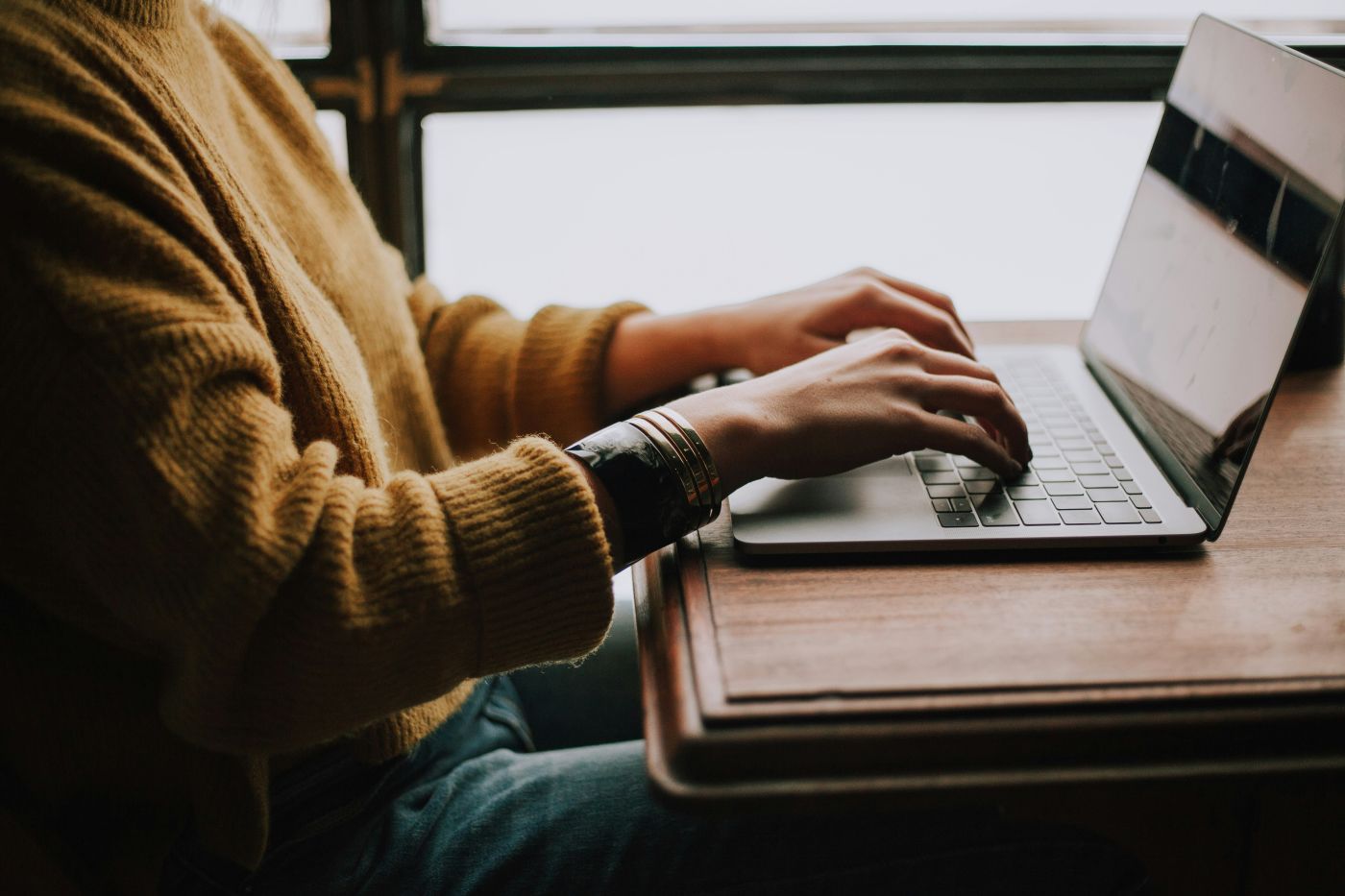 Young female employee working on laptop