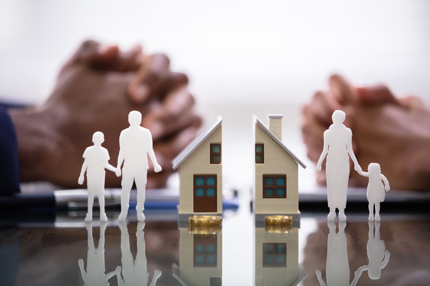 Divorcing couples with split house and family paper model