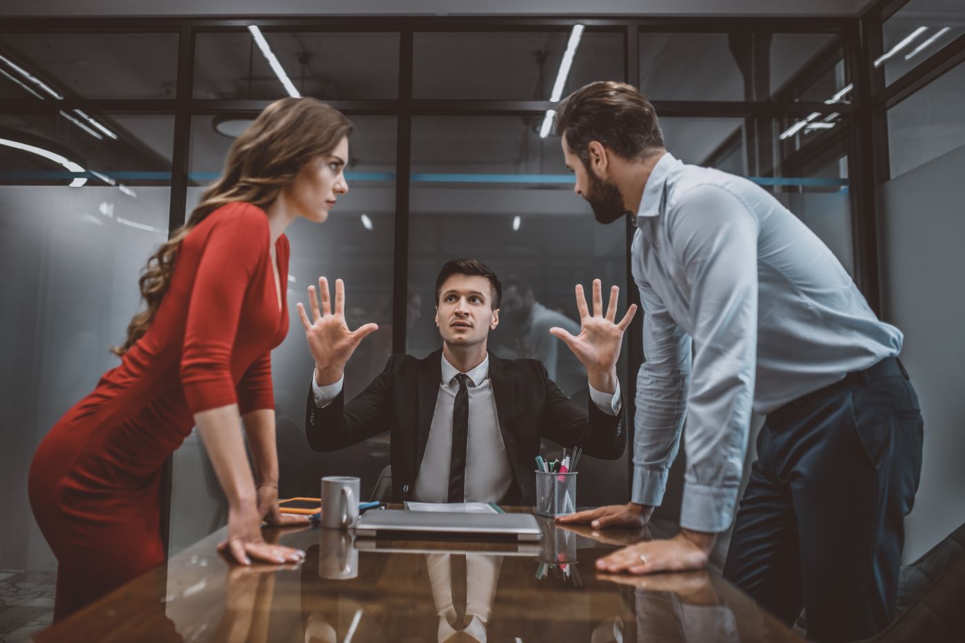 Divorcing couples arguing Infront of attorney