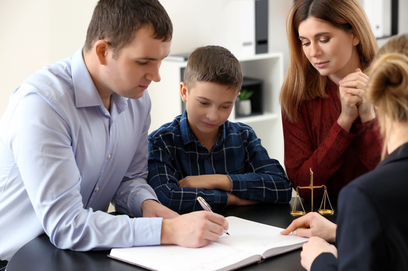 Divorced parents with their son visiting lawyer