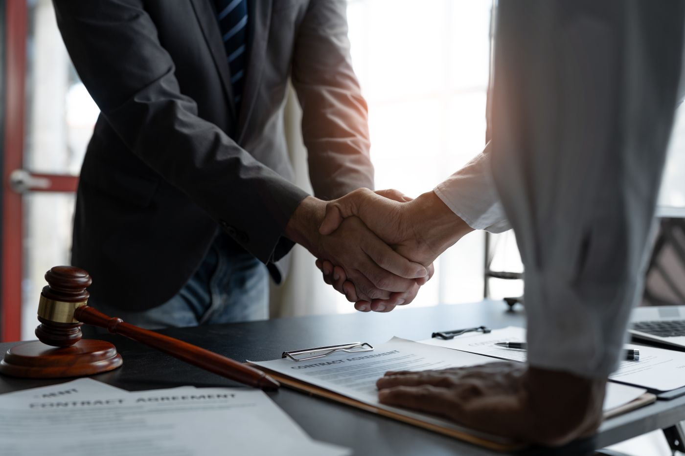 Businessman shaking hand with attorney