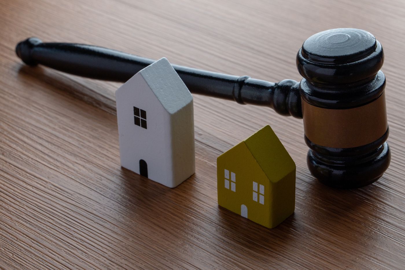 Gavel and miniature wooden house