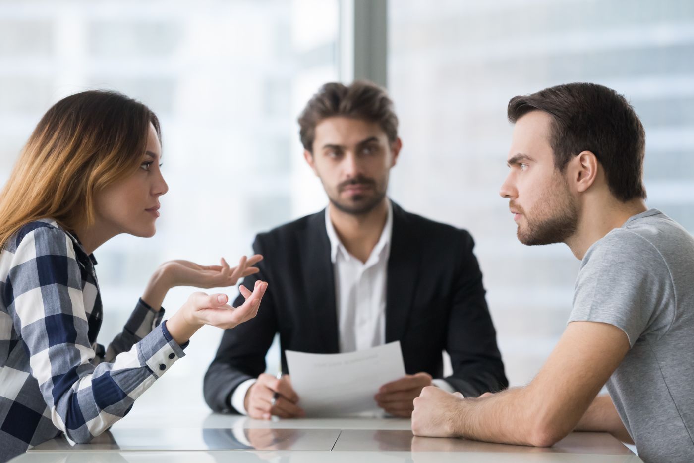 Divorcing couple arguing infront of divorce attorney
