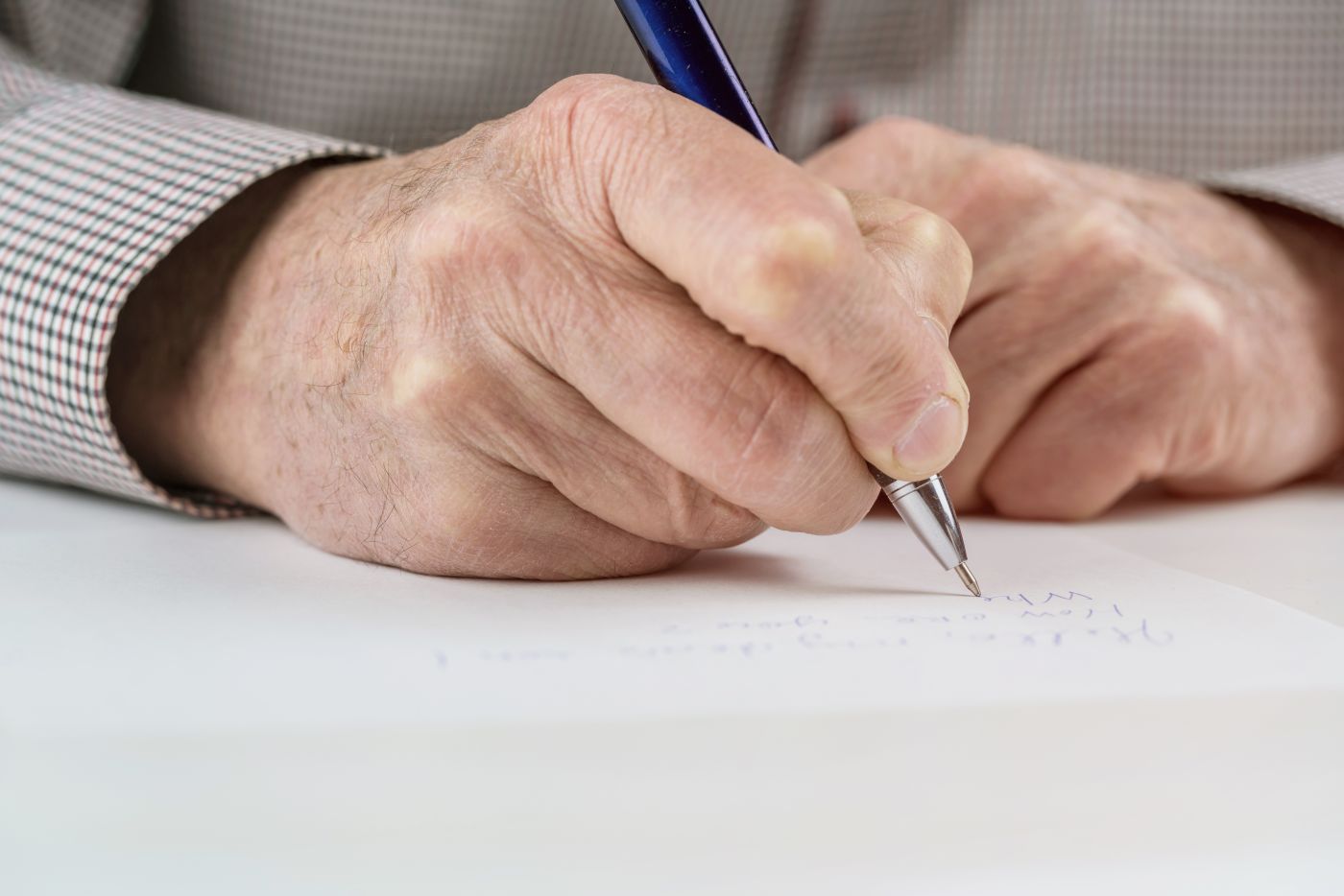 Old hands signing last will document