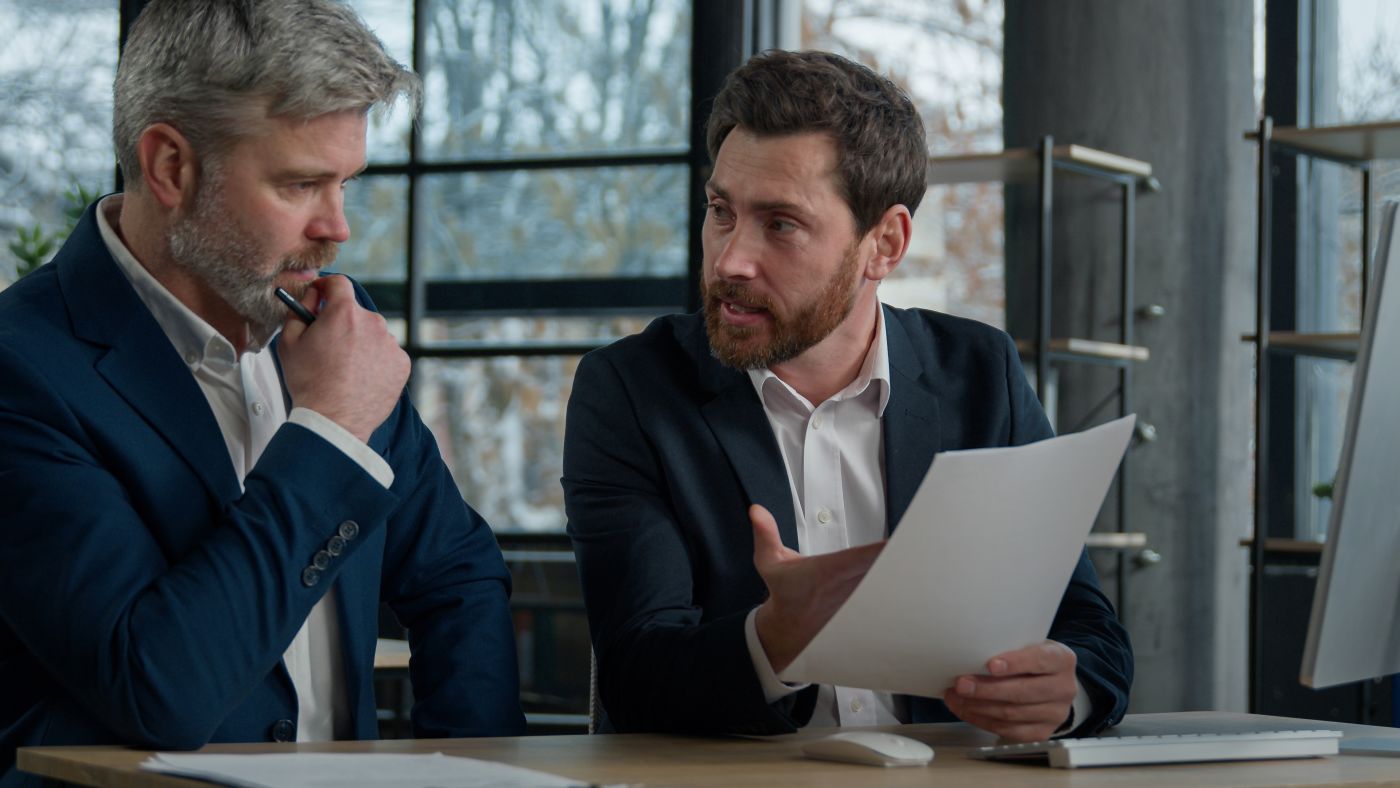 Businessman showing a legal document to his attorney