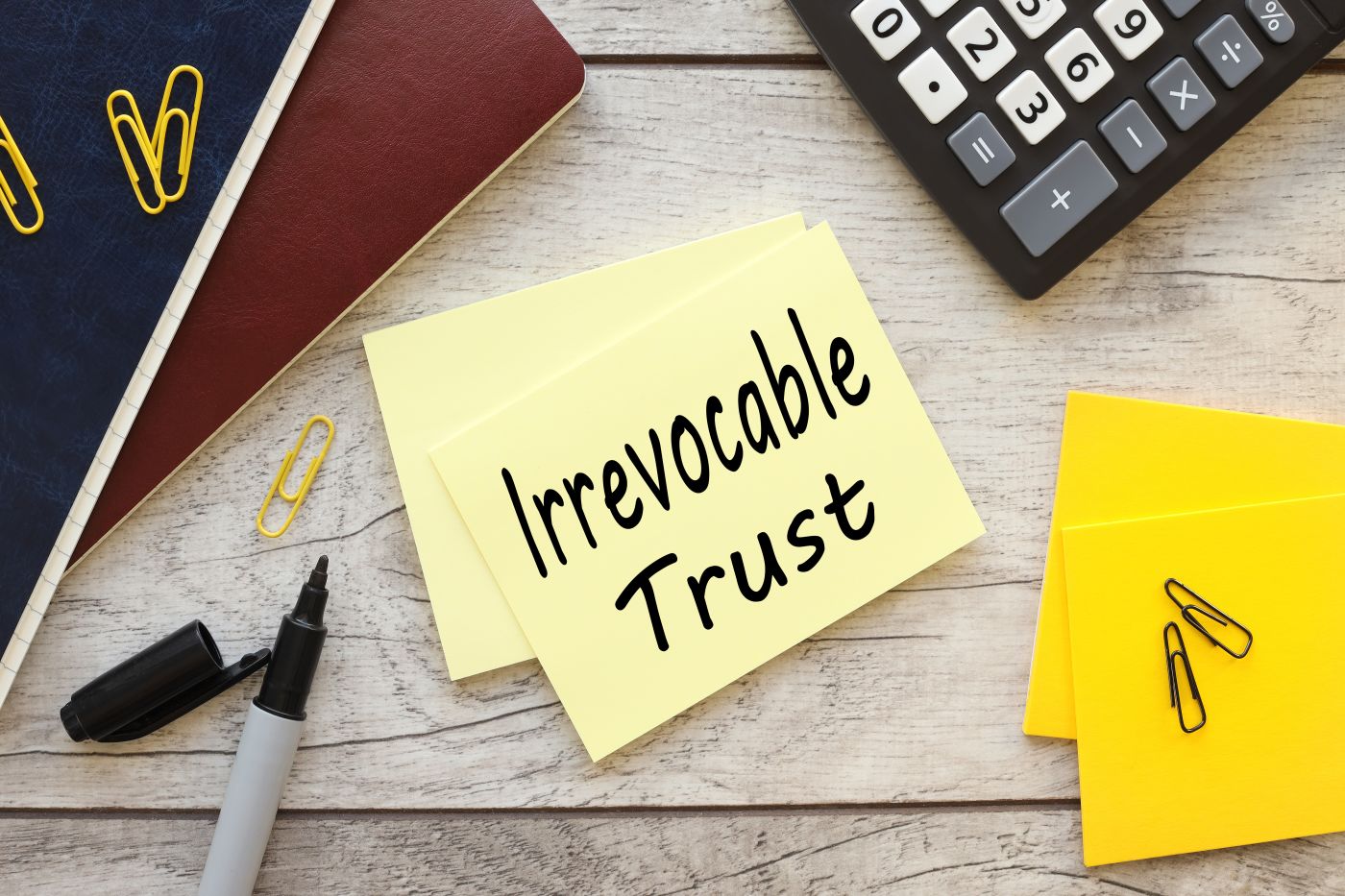 Irrevocable trust text on yellow sticky note