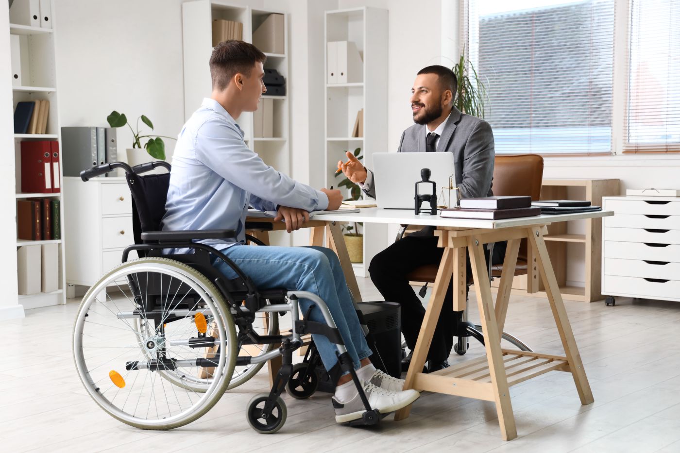 Man in wheelchair consulting with estate planning attorney