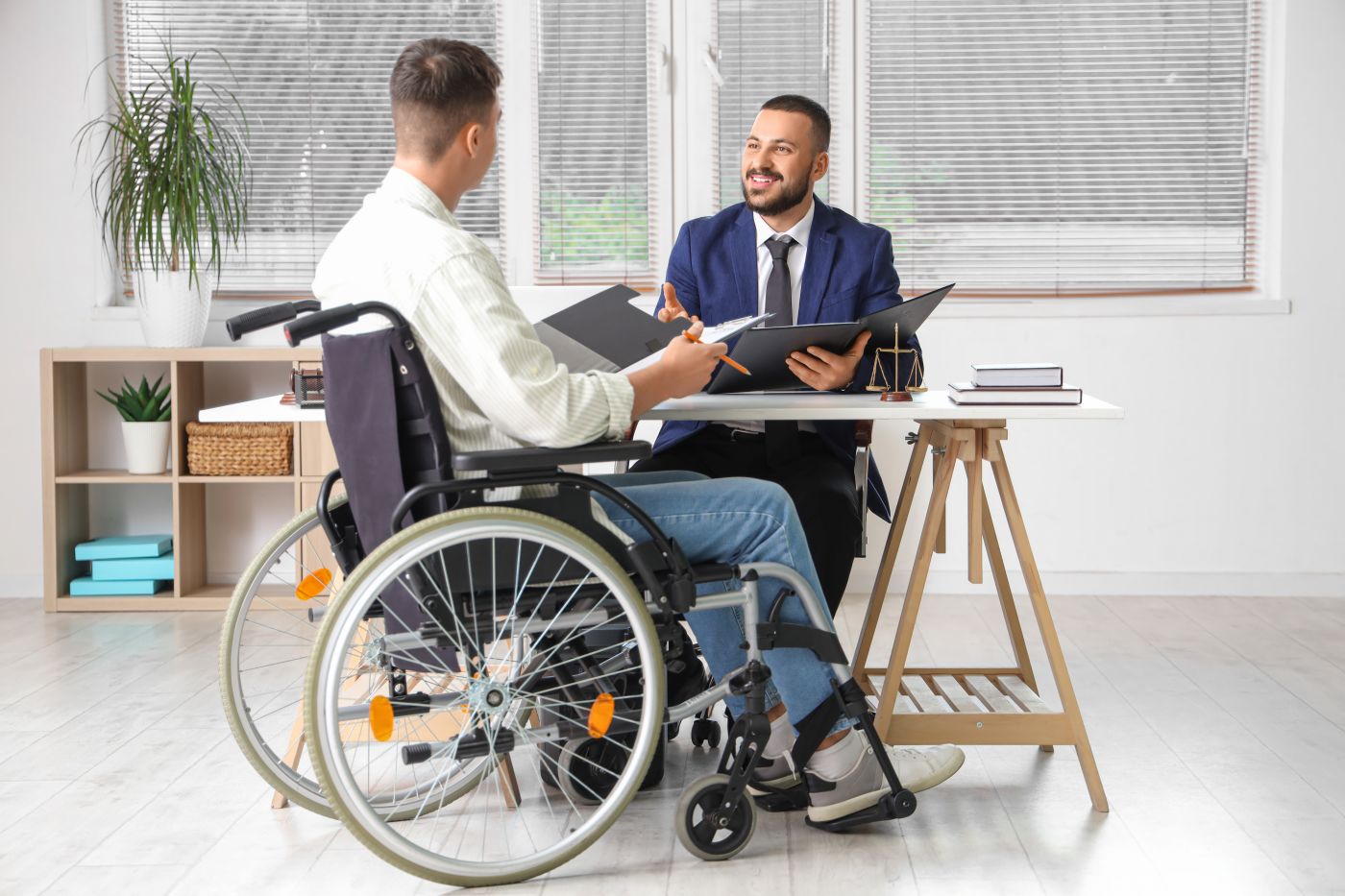 Disabled person in wheelchair consulting attorney