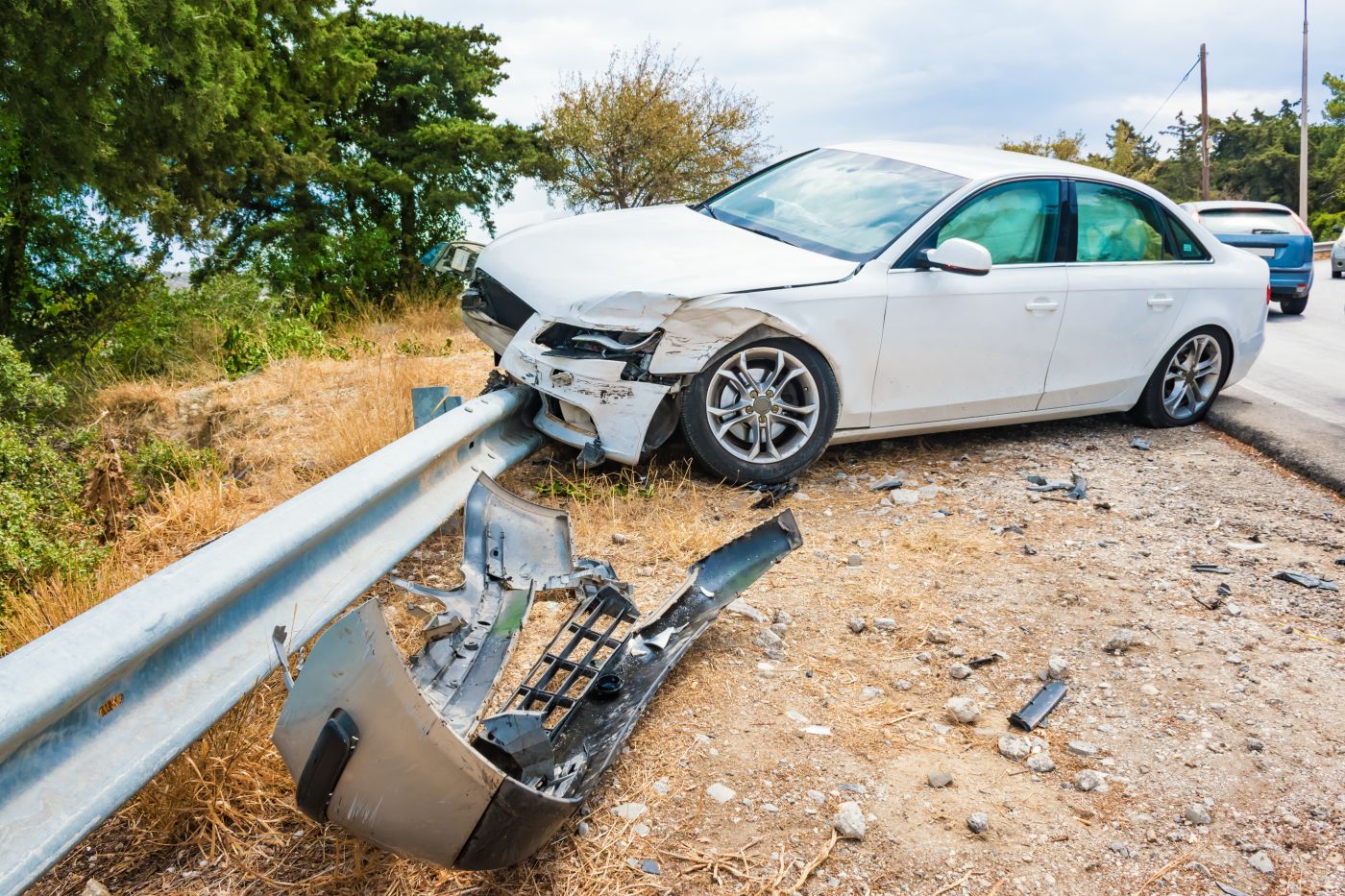 Crashed Car on road side barrier