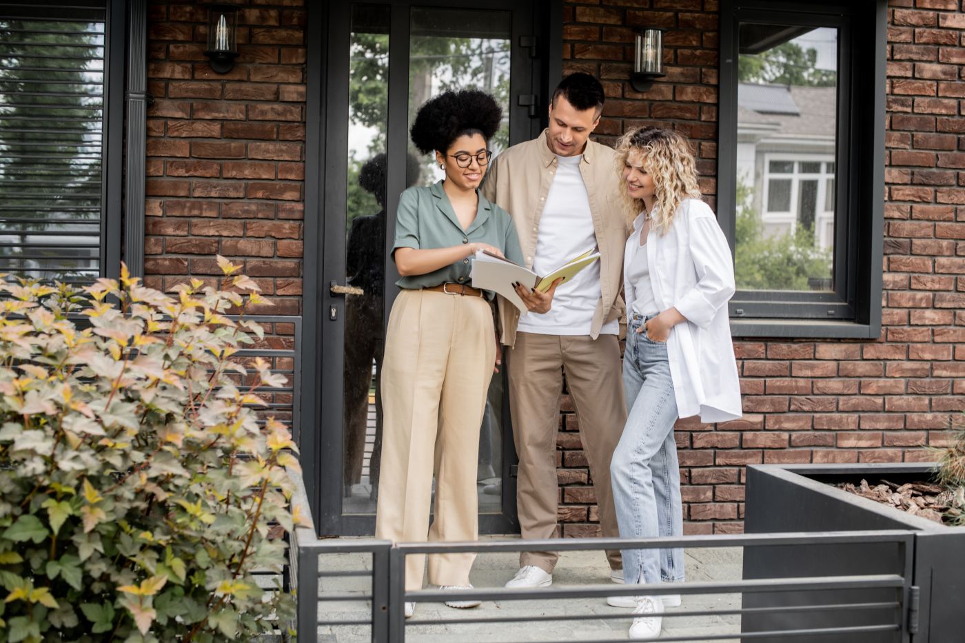 Real Estate agent showing house to young couple