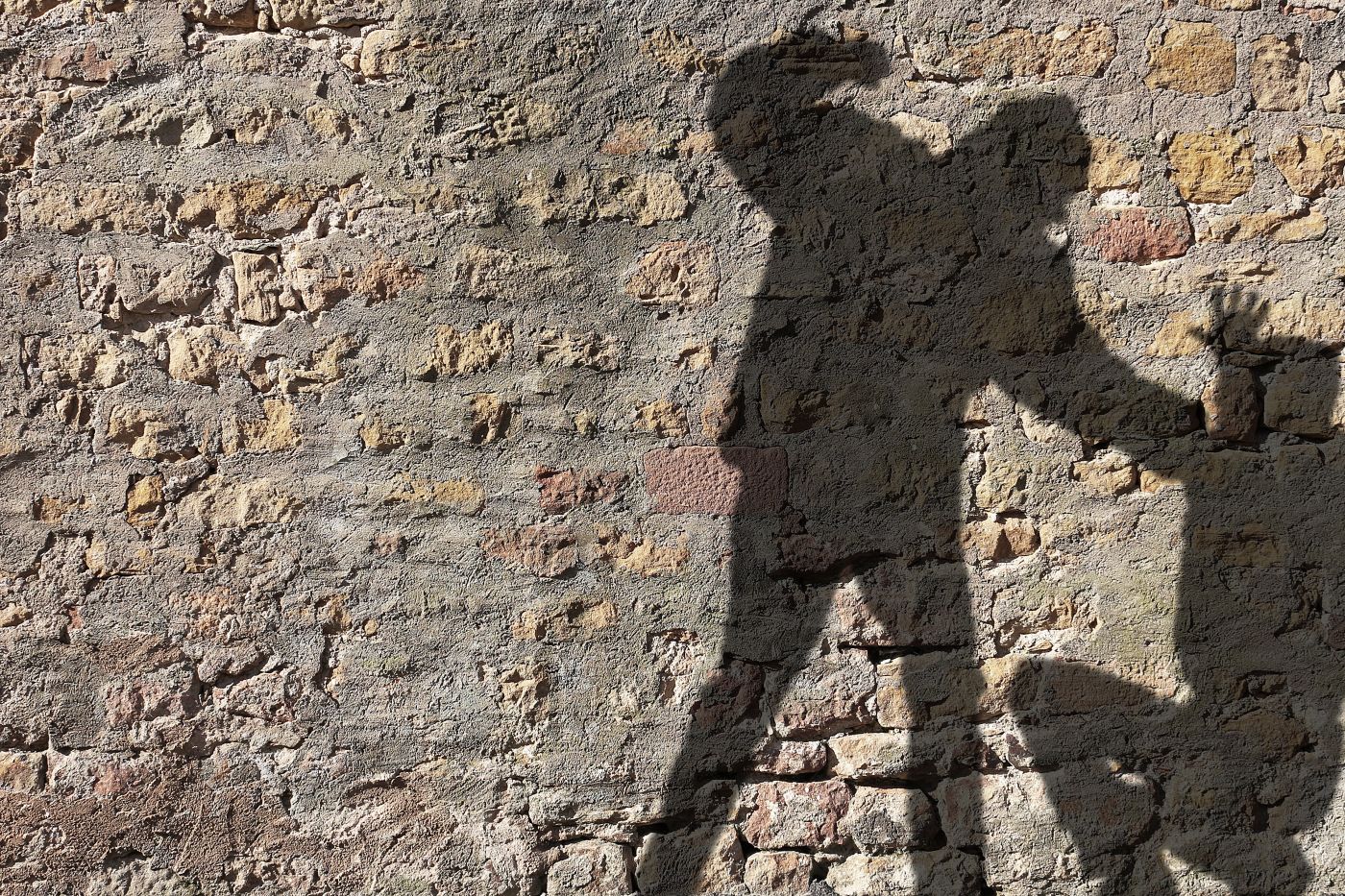Silhouette of a person assaulting another person