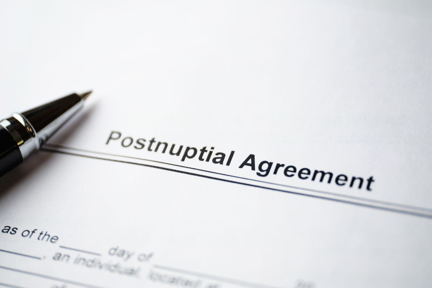 Postnuptial Agreement document on table with pen